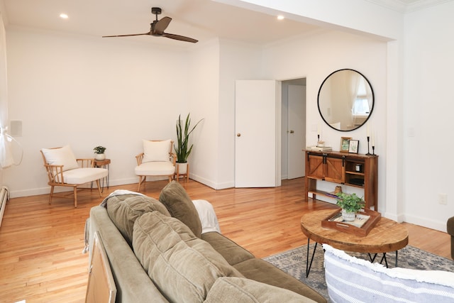 living room with light wood-style floors and ornamental molding