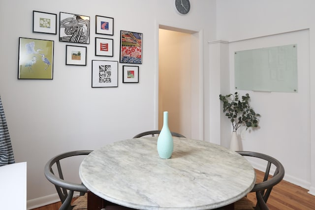 dining room with baseboards and wood finished floors