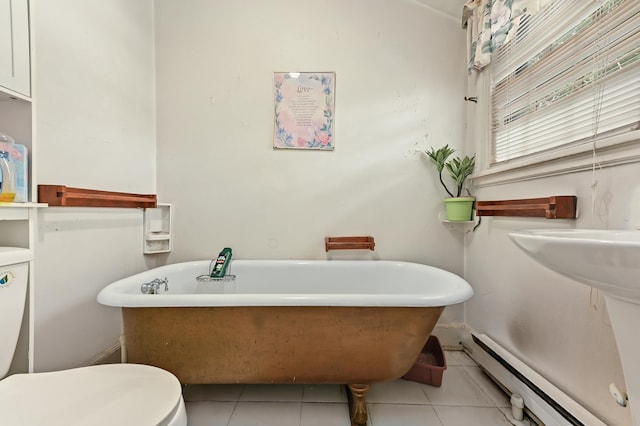 bathroom featuring tile patterned flooring, a washtub, toilet, and a baseboard heating unit