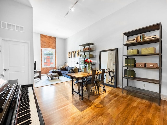 dining area featuring wood finished floors and rail lighting