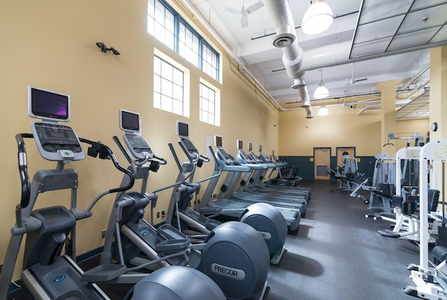exercise room featuring a high ceiling