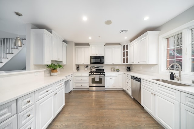 kitchen featuring visible vents, white cabinets, appliances with stainless steel finishes, and a sink