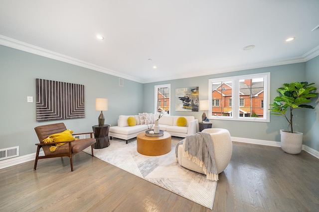 living area with visible vents, crown molding, baseboards, recessed lighting, and wood finished floors