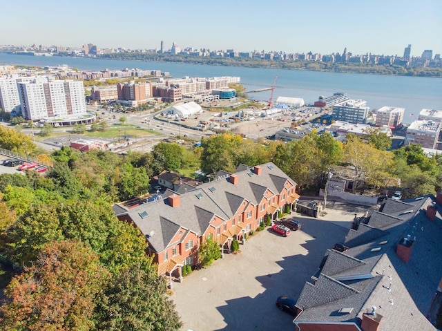 birds eye view of property featuring a view of city and a water view