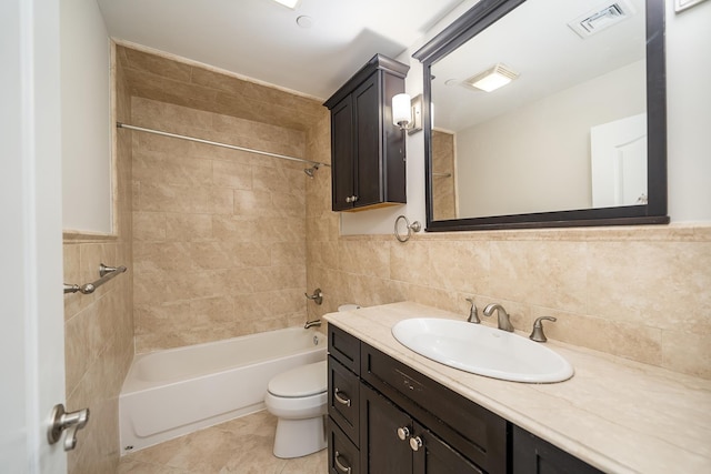 full bath with visible vents, shower / tub combination, tile walls, and toilet