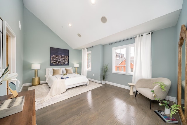 bedroom with baseboards, high vaulted ceiling, and wood finished floors