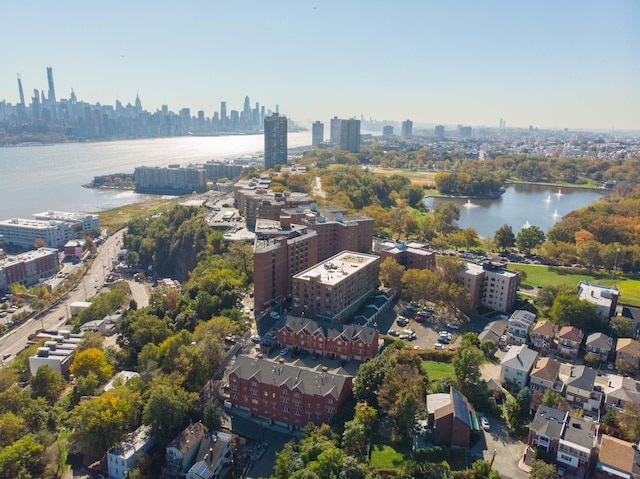 birds eye view of property with a view of city and a water view