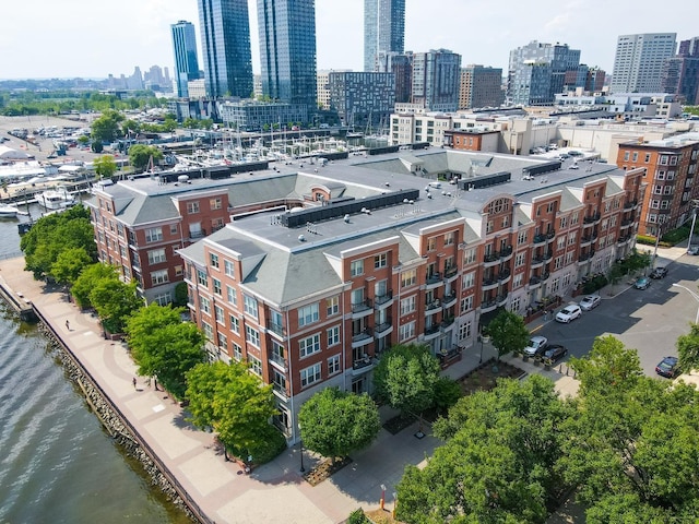 birds eye view of property with a city view and a water view