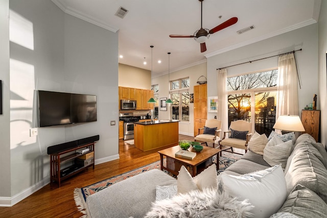 living room with visible vents and crown molding