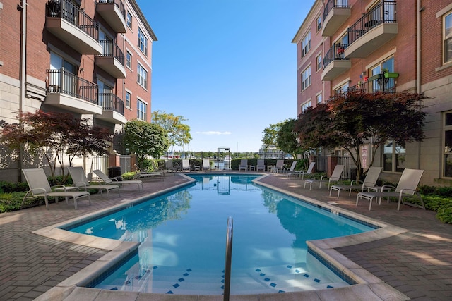 pool featuring a patio area and fence