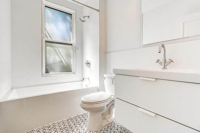 bathroom with plenty of natural light, toilet, vanity, and  shower combination