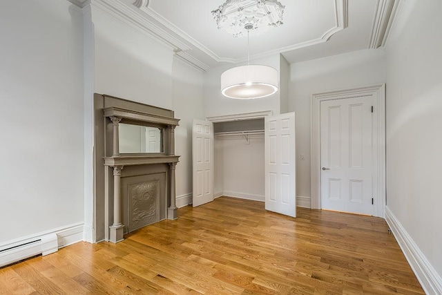 unfurnished bedroom featuring light wood-style flooring, ornamental molding, baseboards, and a baseboard radiator