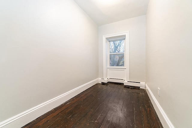 empty room with baseboards and dark wood-style flooring