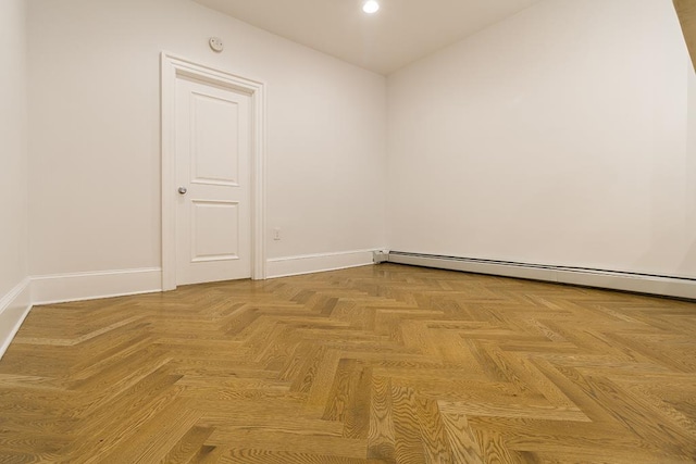 empty room with recessed lighting, a baseboard radiator, and baseboards