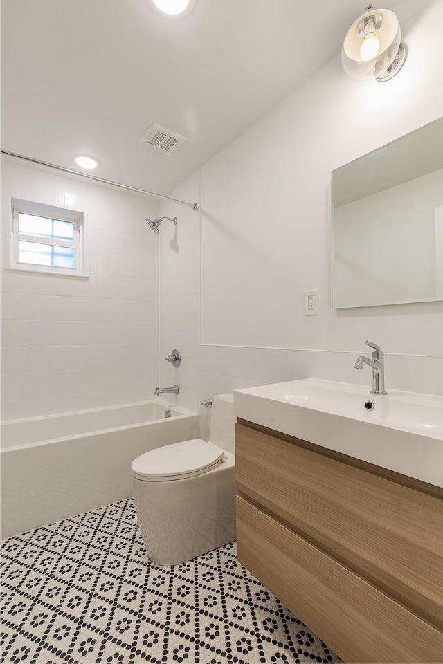 full bathroom with vanity, visible vents, tile patterned flooring, shower / bath combination, and toilet