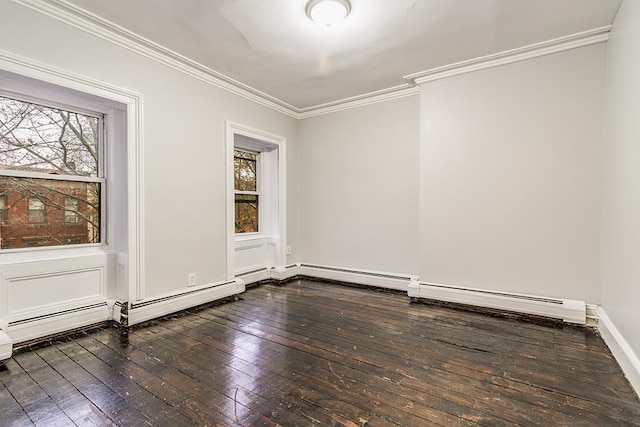 spare room with a baseboard radiator, dark wood finished floors, and crown molding