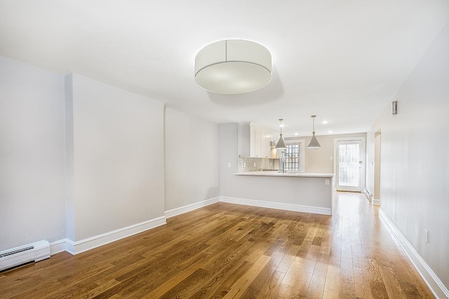 unfurnished living room with recessed lighting, hardwood / wood-style flooring, baseboards, and a baseboard radiator