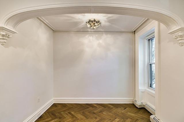 spare room with baseboards, arched walkways, plenty of natural light, and ornamental molding