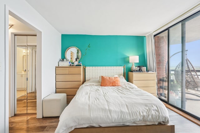 340 Harmon Cove Tower 340, Secaucus, NJ 07094 - bedroom with access to outside, wood finished floors, and a wall of windows
