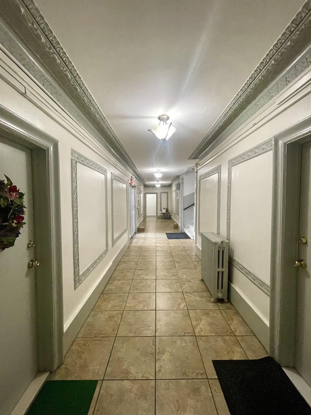 315 56th St Unit D4, West New York, NJ 07093 - hall with radiator heating unit, ornamental molding, and light tile patterned floors