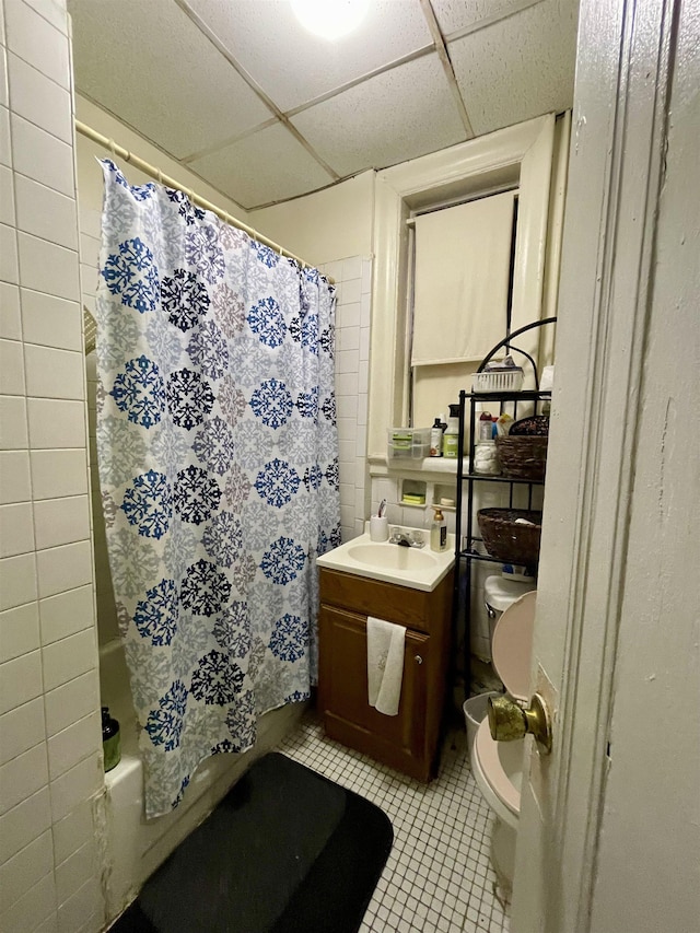 315 56th St Unit D4, West New York, NJ 07093 - bathroom featuring tile patterned floors, vanity, a paneled ceiling, and shower / bath combo with shower curtain