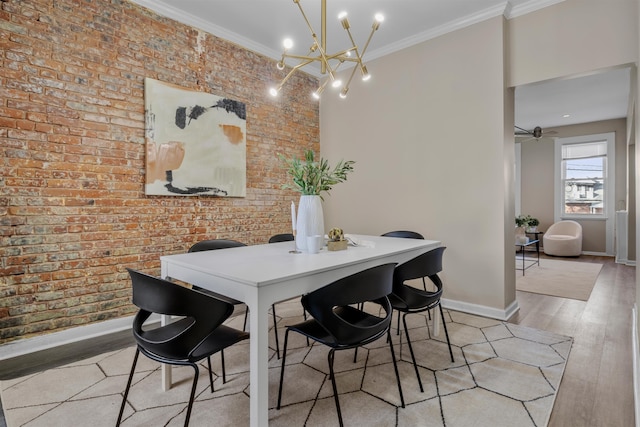 dining area featuring ceiling fan with notable chandelier, brick wall, light wood-type flooring, and ornamental molding