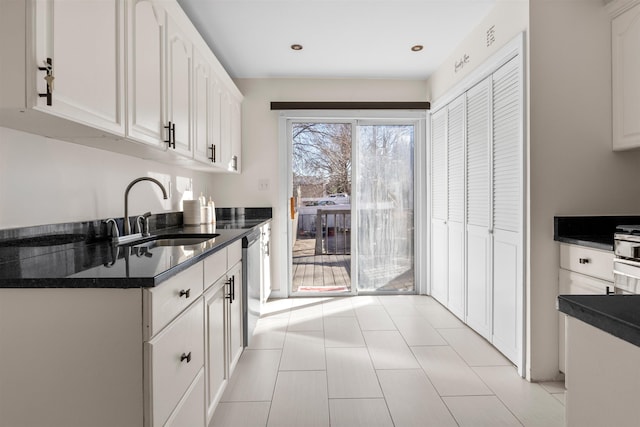 kitchen with white cabinets, stainless steel dishwasher, and sink