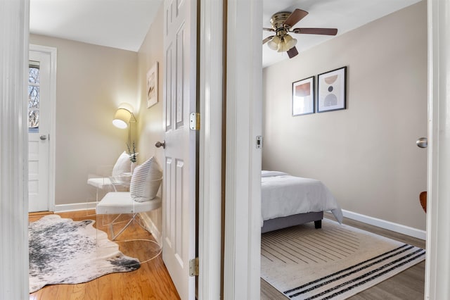 bedroom with ceiling fan and hardwood / wood-style flooring