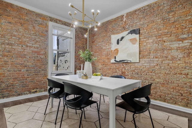 dining room featuring brick wall, an inviting chandelier, crown molding, and light hardwood / wood-style flooring