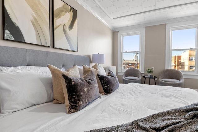 bedroom with ornamental molding and vaulted ceiling