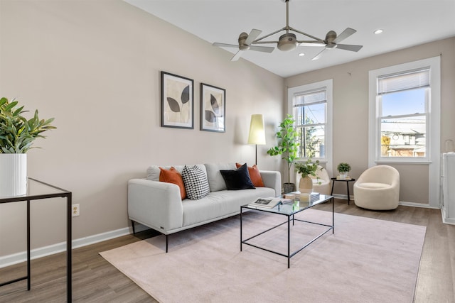 living room featuring ceiling fan and light wood-type flooring