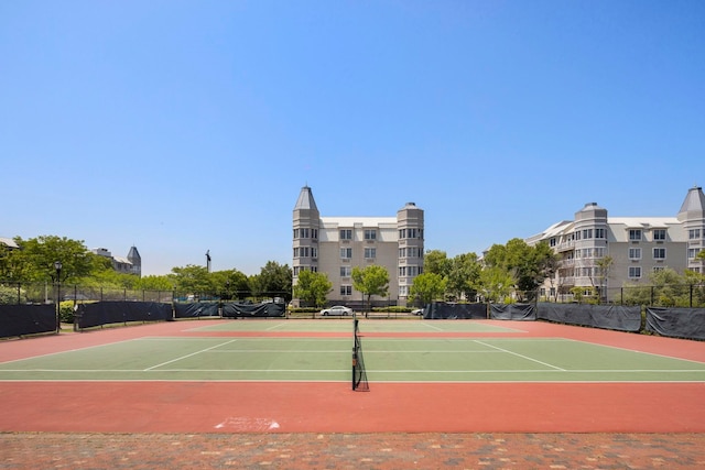 view of tennis court featuring basketball hoop