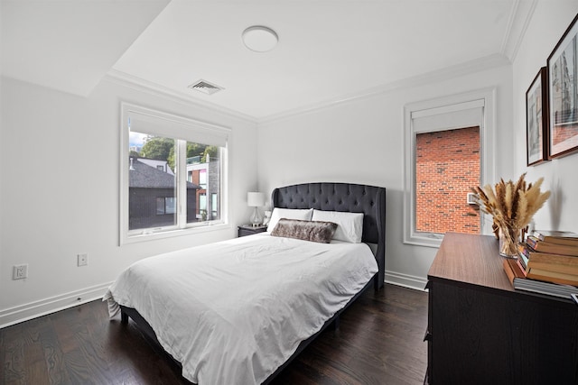 bedroom with dark hardwood / wood-style floors and ornamental molding