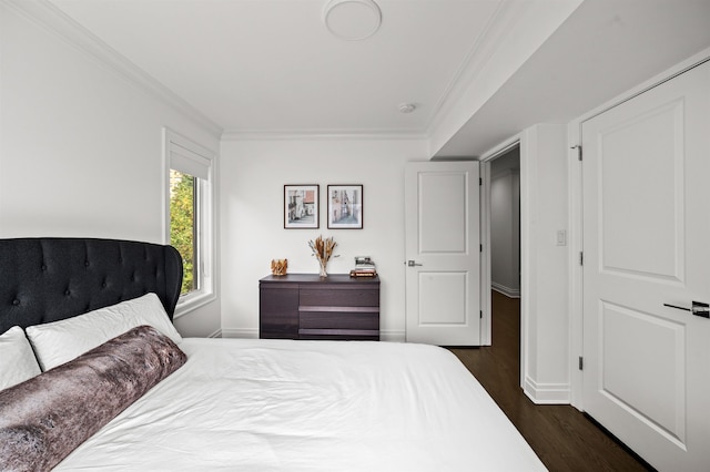 bedroom with ornamental molding and dark wood-type flooring