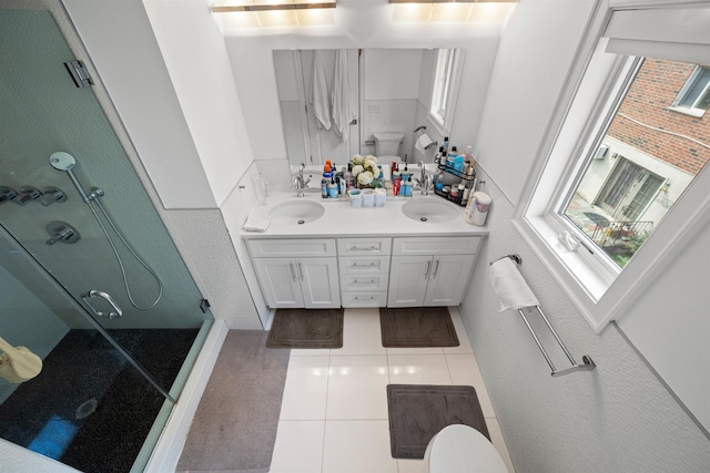 bathroom with vanity, toilet, a wealth of natural light, and walk in shower