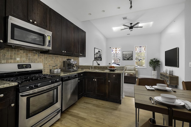 139 Morris St Unit 7, Jersey City, NJ 07302 - kitchen featuring appliances with stainless steel finishes, light wood-type flooring, a sink, backsplash, and a ceiling fan