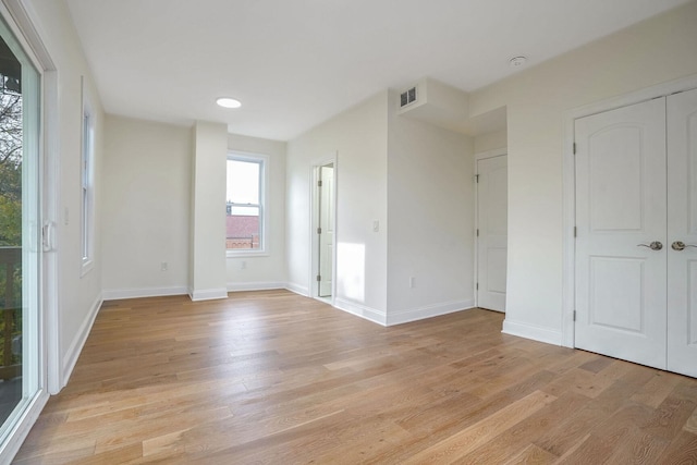 unfurnished bedroom with access to outside and light wood-type flooring