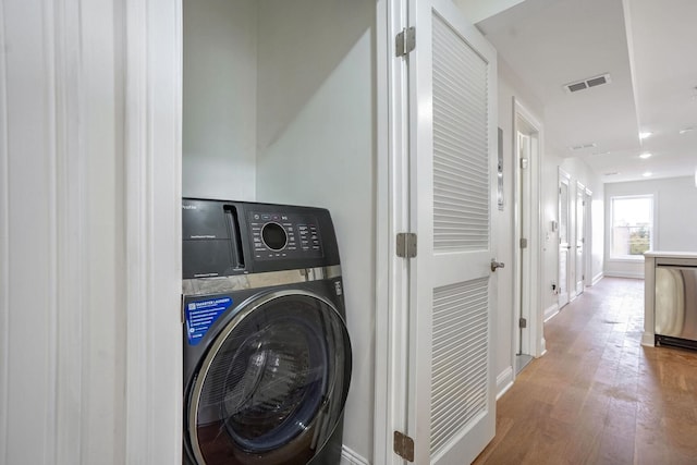 laundry room with wood-type flooring and washer / clothes dryer