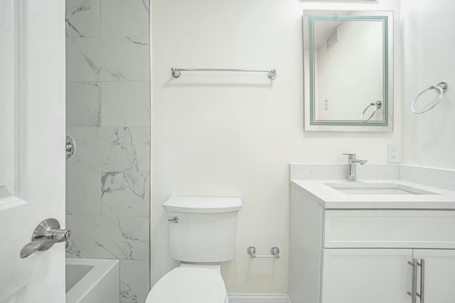 full bathroom featuring vanity, tiled shower / bath combo, and toilet