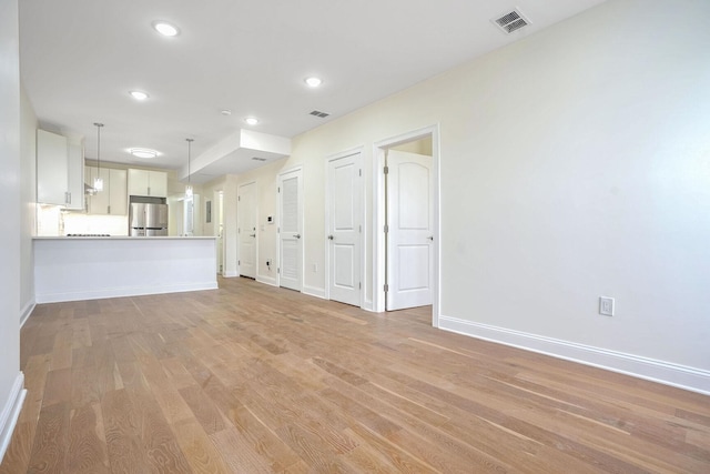 unfurnished living room with light wood-type flooring