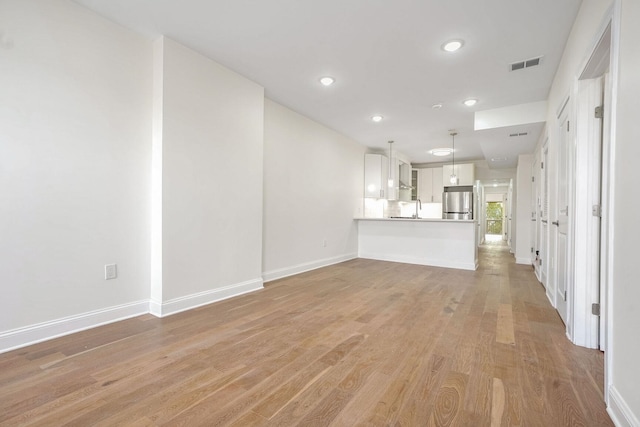 unfurnished living room featuring light wood-type flooring