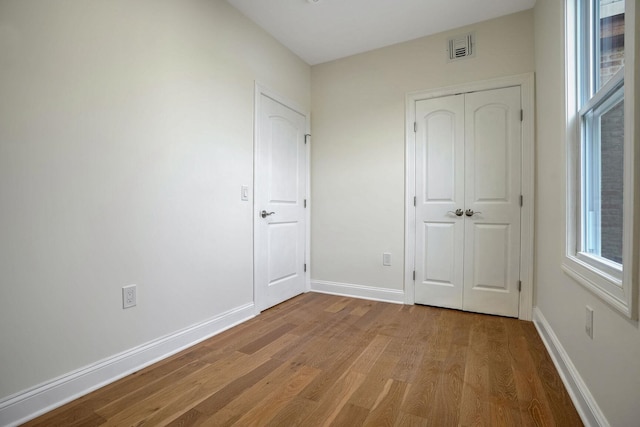 unfurnished bedroom featuring a closet and wood-type flooring