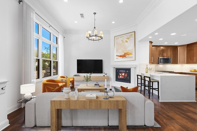 15 Warren St Unit 102, Jersey City, NJ 07032 - living area featuring crown molding, a chandelier, a glass covered fireplace, dark wood finished floors, and recessed lighting