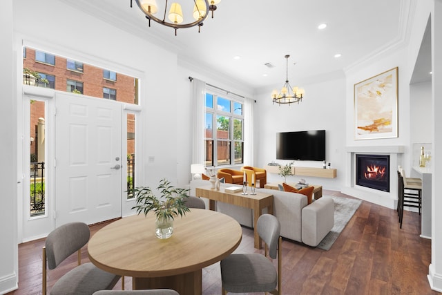 15 Warren St Unit 102, Jersey City, NJ 07032 - living room featuring a chandelier, ornamental molding, dark wood-style floors, recessed lighting, and a glass covered fireplace