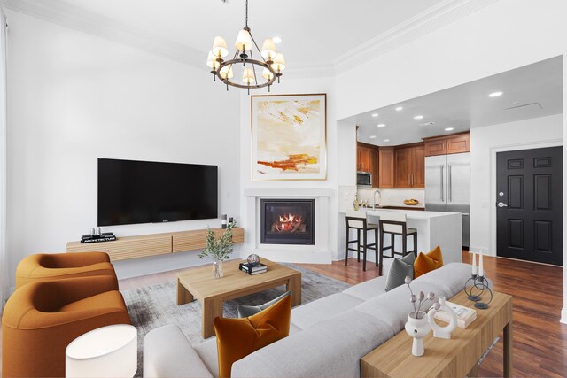 15 Warren St Unit 102, Jersey City, NJ 07032 - living area featuring ornamental molding, a chandelier, recessed lighting, a glass covered fireplace, and dark wood-type flooring