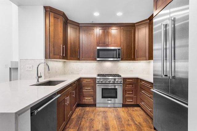 15 Warren St Unit 102, Jersey City, NJ 07032 - kitchen with premium appliances, a sink, dark wood-style flooring, tasteful backsplash, and recessed lighting