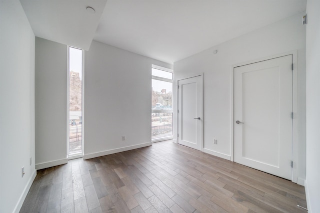800 Ave At Port Imperial Unit 323, Weehawken, NJ 07086 - unfurnished bedroom with wood finished floors and baseboards