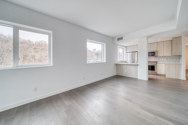 800 Ave At Port Imperial Unit 323, Weehawken, NJ 07086 - unfurnished living room with light wood-style flooring and baseboards