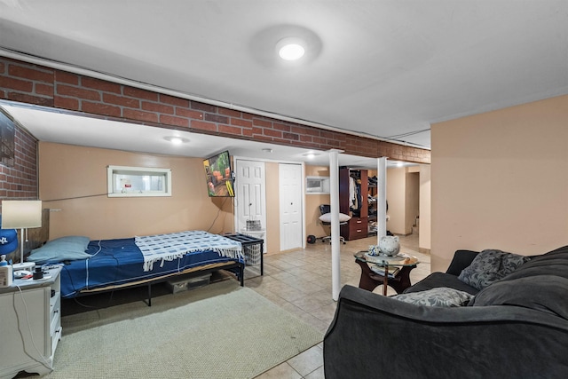 1501 41st St, North Bergen, NJ 07047 - bedroom with brick wall and light tile patterned floors
