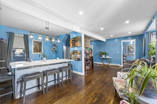1501 41st St, North Bergen, NJ 07047 - kitchen with wood finished floors, baseboard heating, recessed lighting, a center island with sink, and a kitchen breakfast bar